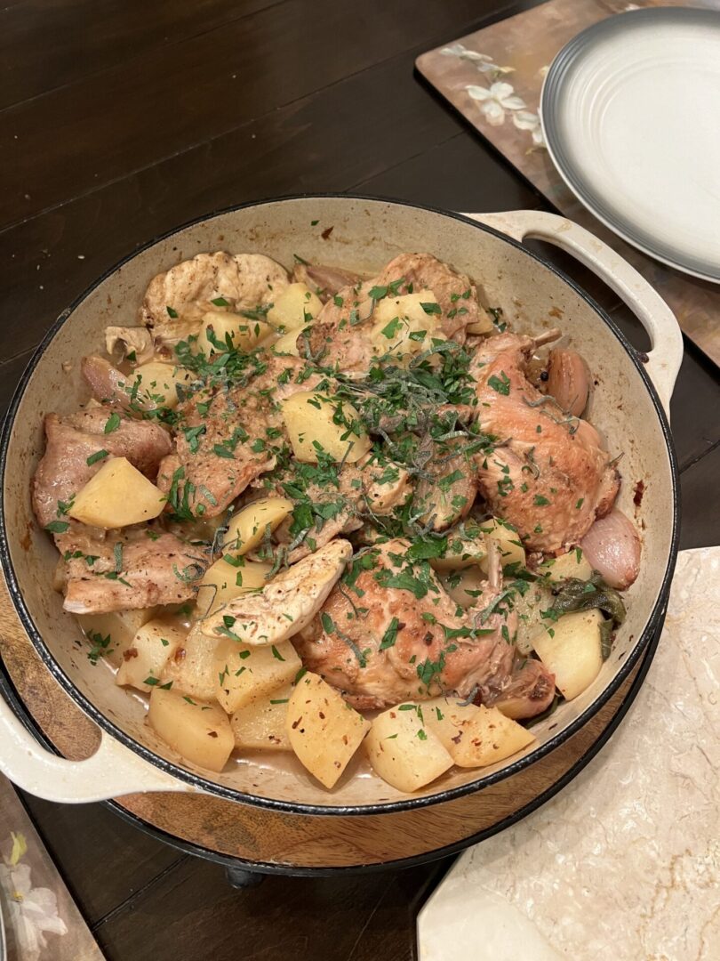 A bowl full of vegetables and meat kept on a floor